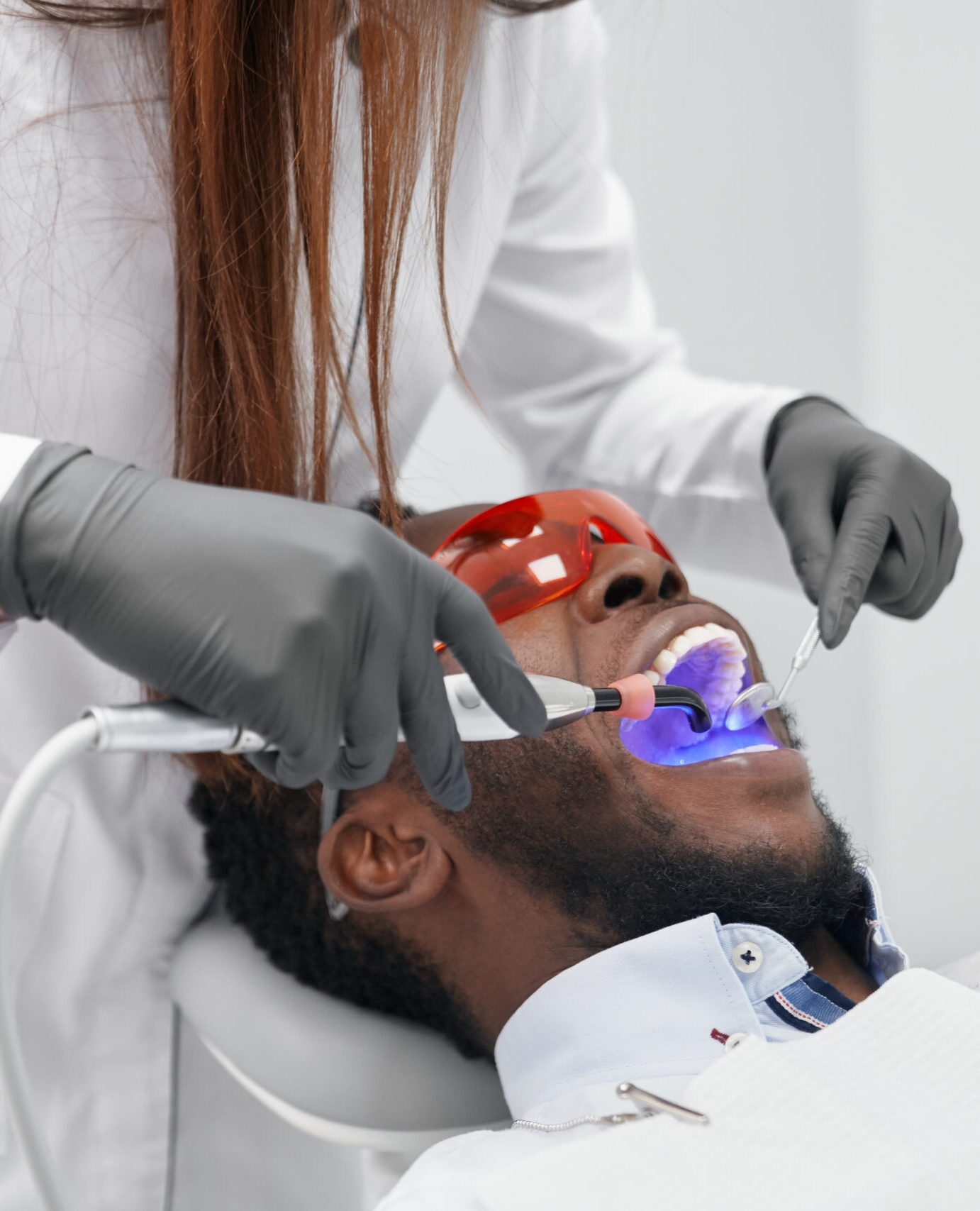 View from side of female doctor in process of doing filling